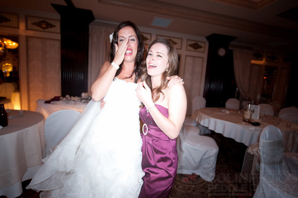 The bride and her maid of honor share a laugh.