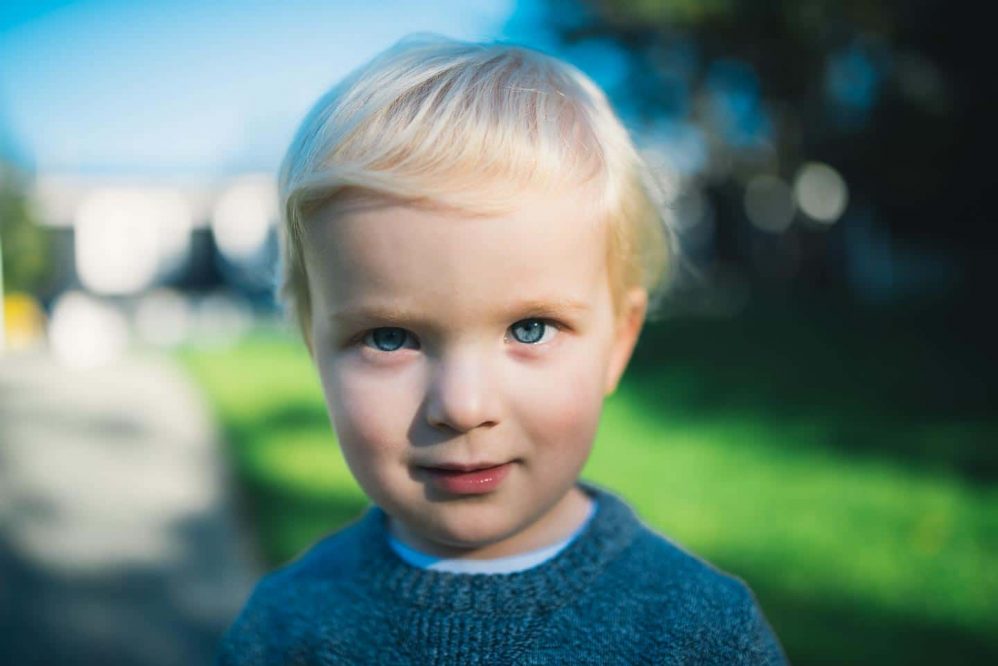 A young boy stares into the camera lens for his portrait.