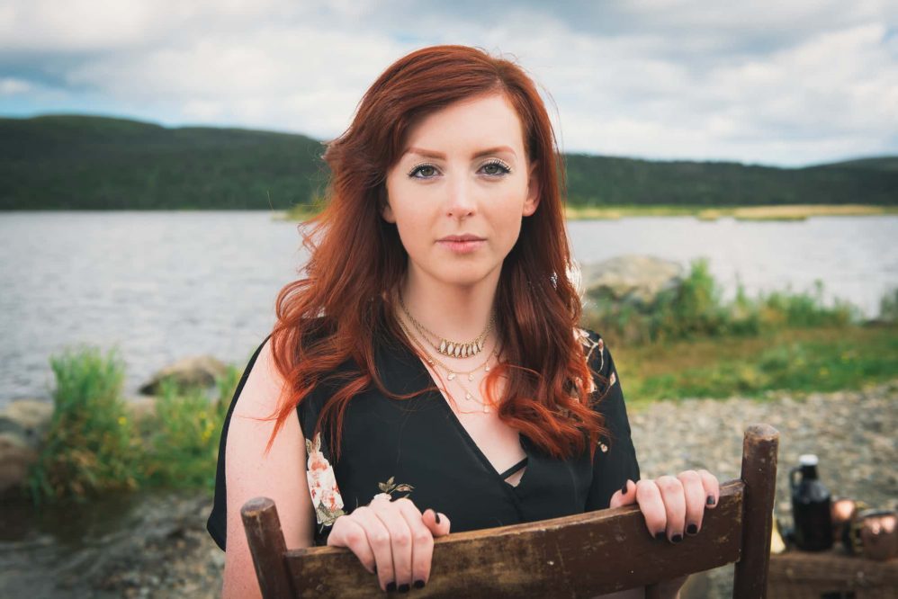 A woman with lovely red hair poses for a picture.