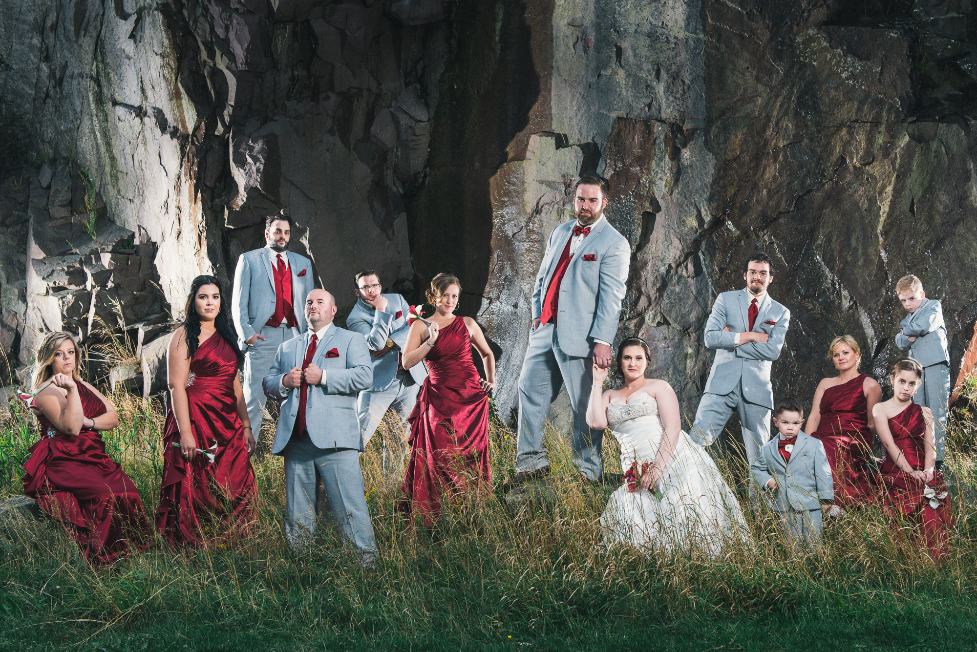 A stunning photograph shows the entire bridal party posing like celebrities in front of a natural cliff