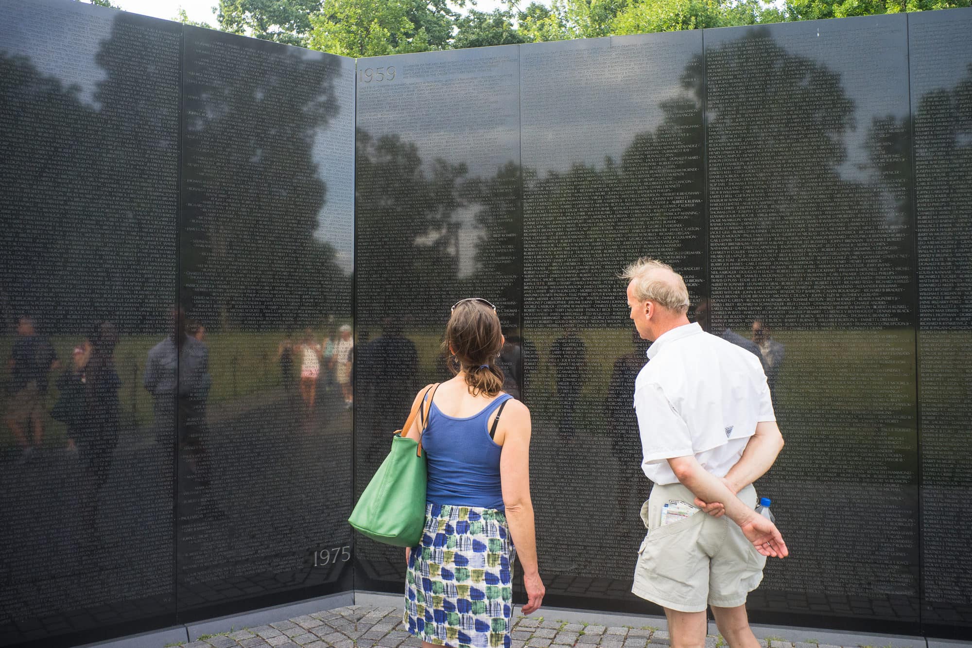 Washington, D.C. - At the Vietnam War Monument two visitors view the beginning and the end of the list of names.