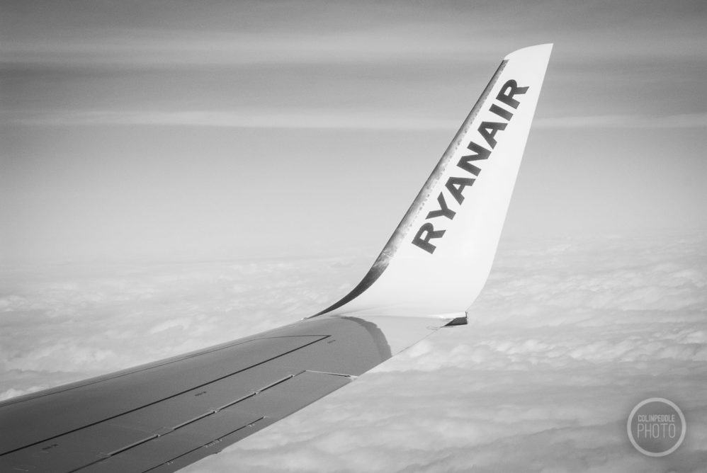 A photograph out the aircraft window of a Ryanair winglet.