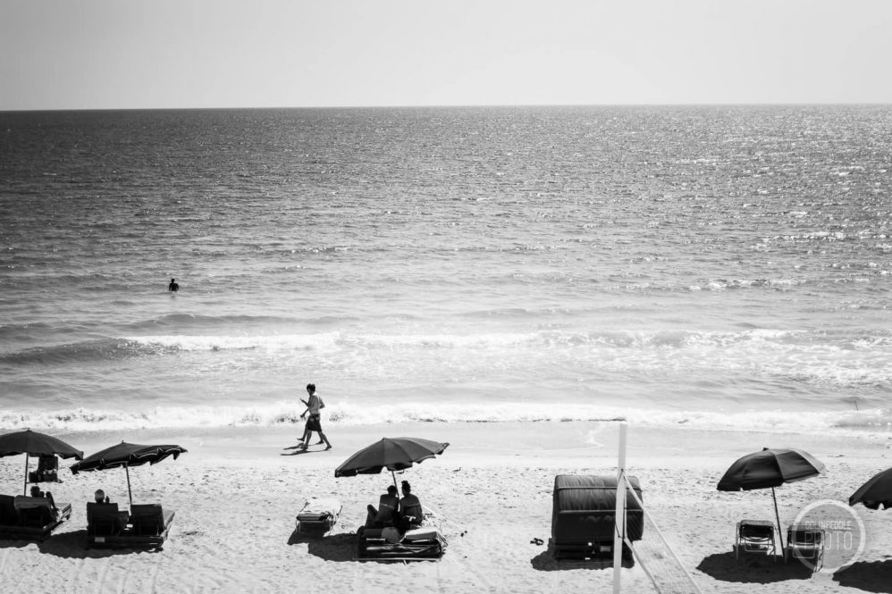 A couple walk on the beach along the ocean surf in Sarasota, Florida, USA