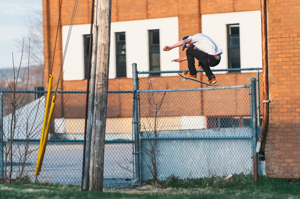 Mike Hudson with the massive ollie over the sketchy chain link fence.