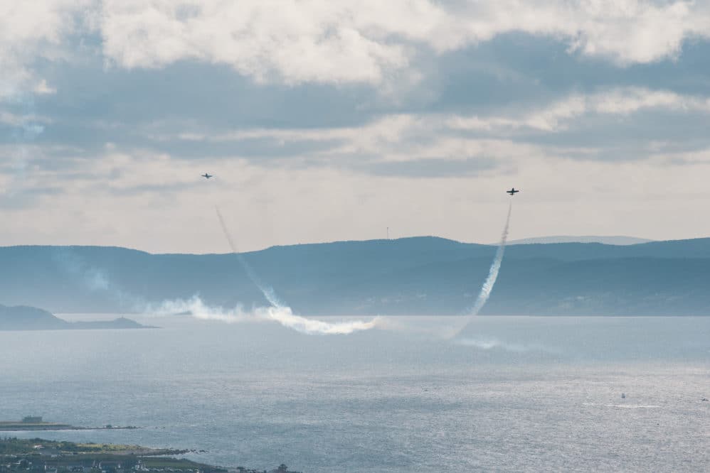 Two Snowbirds buzz the water in close quarters flying over CBS in Newfoundland.