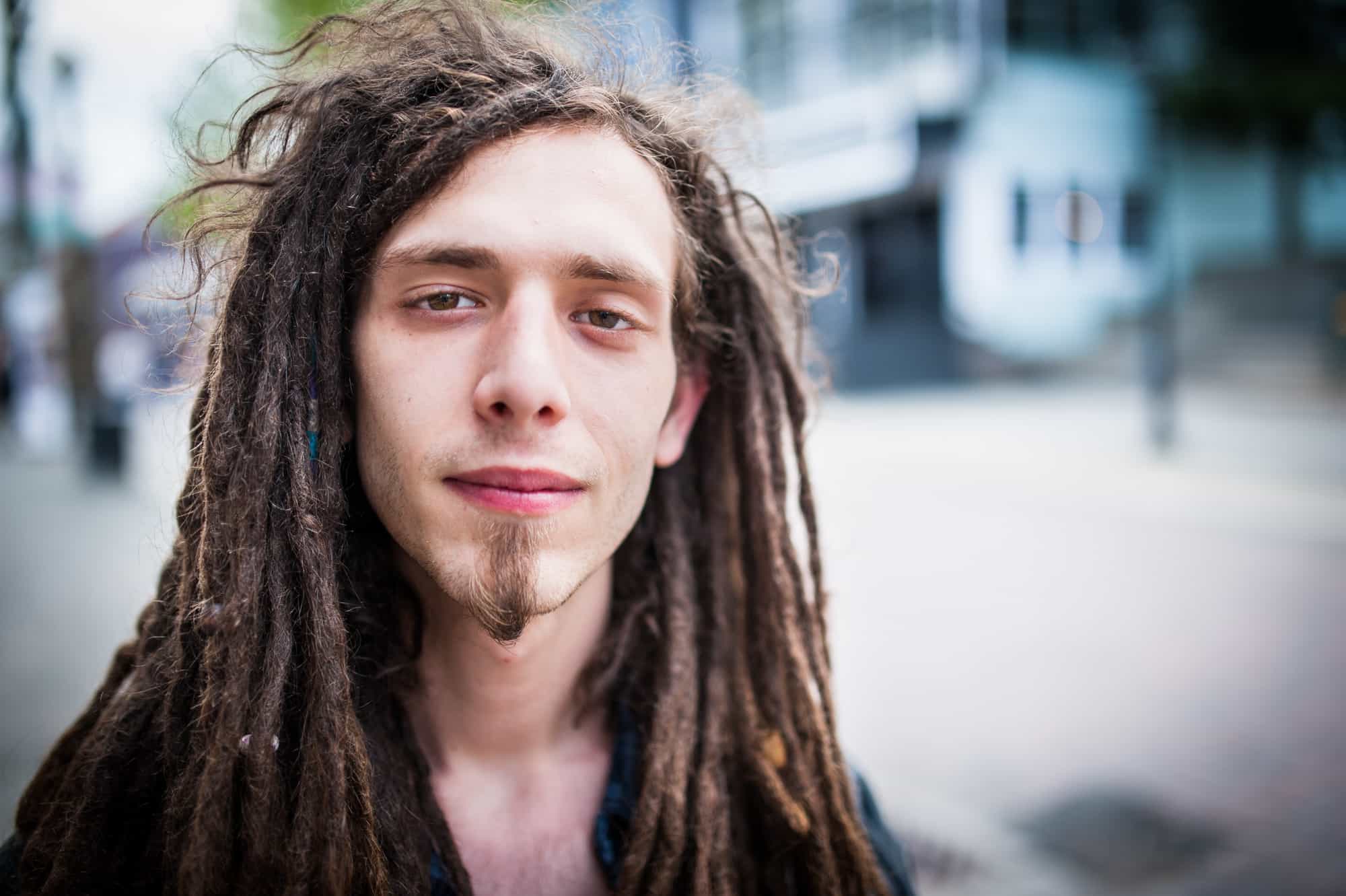 A young man with dreads and goatee is photographed on George Street in Newfoundland.