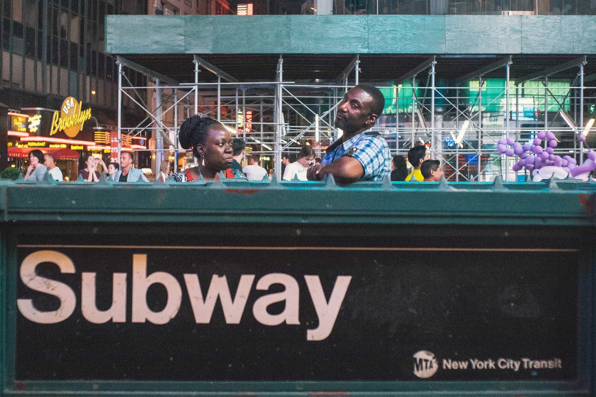 A couple hang out in Manhattan at night.