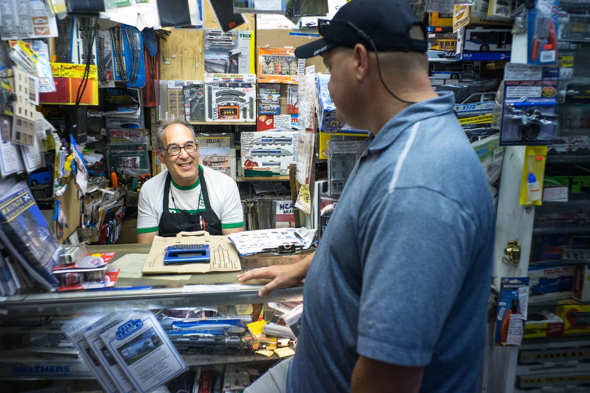 The owner of the Red Caboose Hobby Shop speaks with a customer.