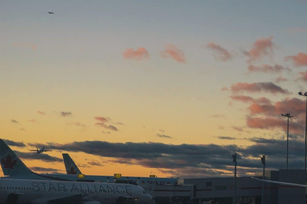 CYYZ with multiple Air Canada planes on the tarmac and in the sky.