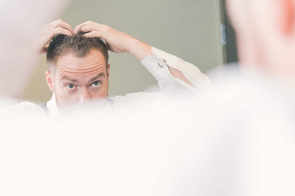 Our groom getting his hair just right!