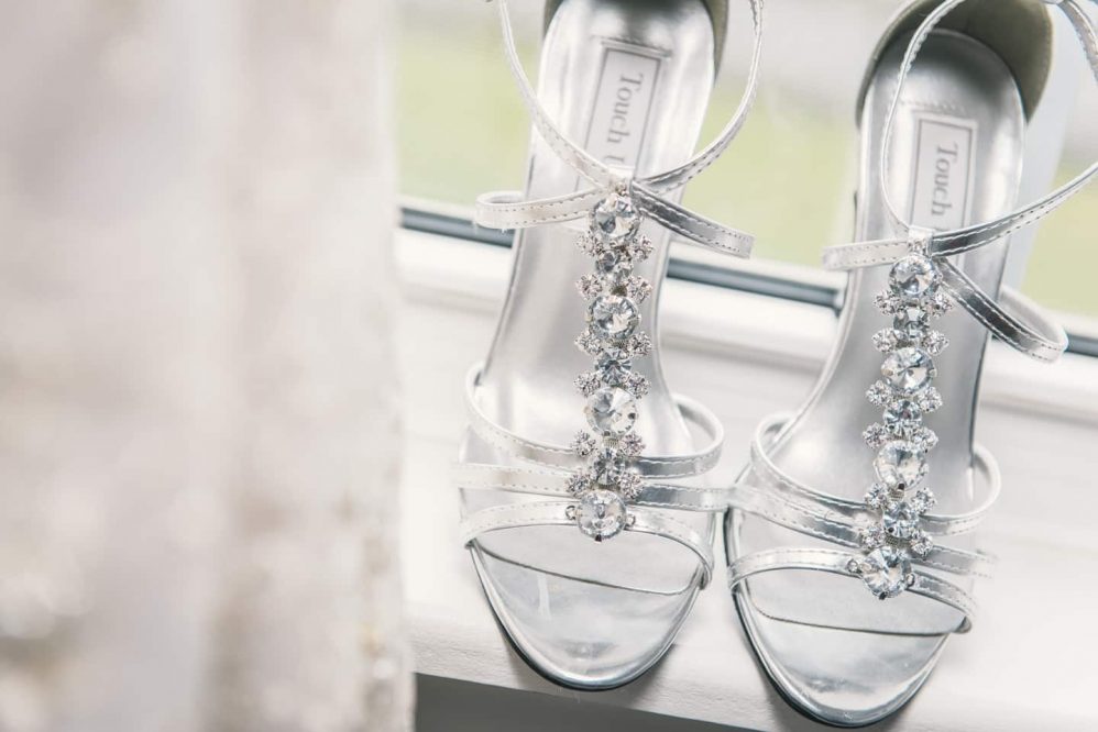 Wedding shoes next to the dress.