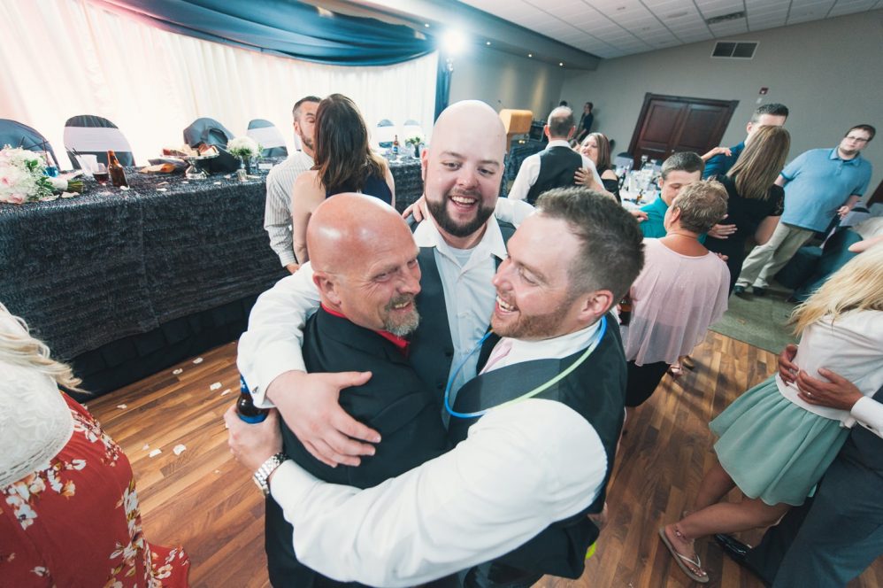 The boys all dance around at their wedding reception.