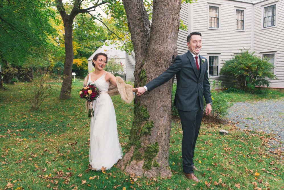 A bride and her groom share a touch before their first look.