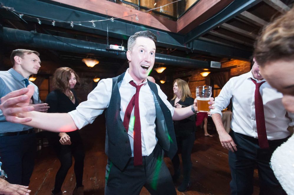 The groom having some fun during his wedding reception.