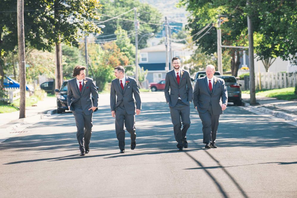 The groomsmen trot up the street on a lovely September morning just hours before his wedding day.
