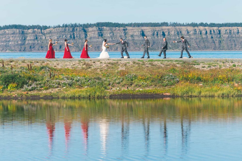 The bridal party reenacts the Beatles album cover photograph.