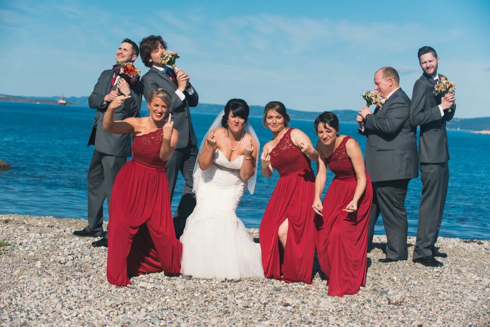 The entire bridal party poses for a funny photograph.