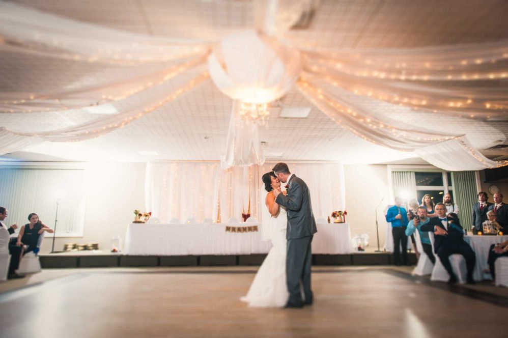 A bride and groom share their first dance at their wedding reception.