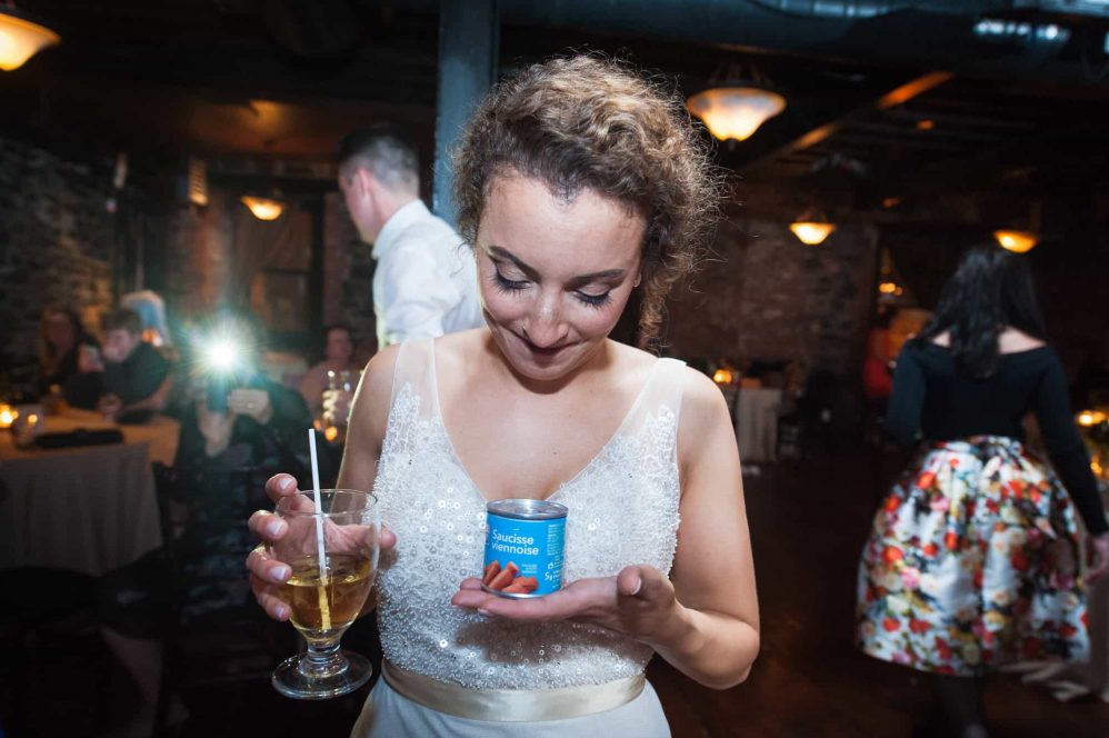 a bride poses with a can of vienna sausages.