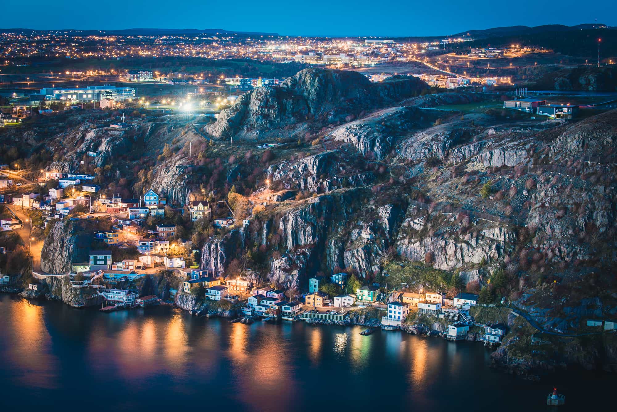 A new angle on a familiar face. The Outer Battery of St. John's from high above at twilight. One of my all time favorites. The Outer Battery might be one of the most colorful areas in all of St. John’s. The one road village at the bottom of a cliff was once a former fishing community and it still shows, as old fishing stages still line the harbors edge. This picture of the Outer Battery area was one of those “almost never happened” photos and, despite the proximity to the city, one of the slightly riskier photos I’ve hiked to shoot. Being surrounded by complete darkness atop the top of the Southside Hills is not fun. Trails that go off in every direction and peril awaits with steep cliffs and drops a constant presence. Several times we discussed and assessed our risk and whether or not we should turn back. It sounds silly, the city is right there. But honestly it only takes one misstep to find yourself down an embankment. Though I had a headlamp we took care to comment on our reverse markers as we made our way off trail to where I needed to be to shoot this photo. All of this made for an easy but still dangerous exit off the hill because the trail down the hill is damp, slippery and rather steep in several sections. Definitely not something I’d have enjoyed doing alone.