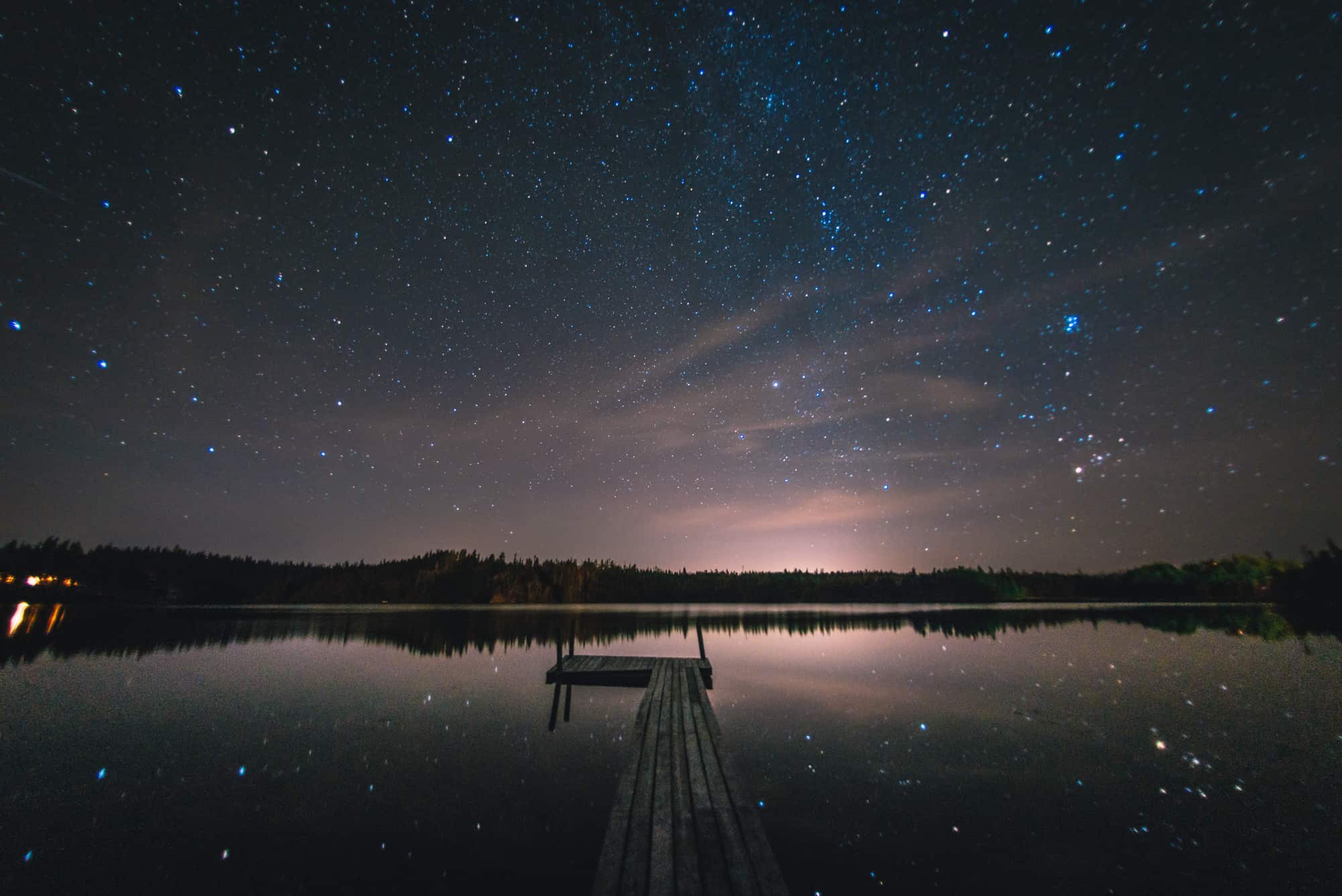 Sometimes you’ve just got to stop and look up at the stars to realize we’re ever so insignificant in this Universe of ours. And I spent this evening doing just that. Relaxing on the wharf with the entire sky above me, not a breathe of wind in the air on a surprisingly warm September evening. Amazing. Rarely will all of the requirements for an evening shooting the stars combine in such a delightful way: The moon had set at twilight. There was barely a cloud in the sky. The wind was calm, ensuring a glass like finish to the lake. And lastly, I was far enough away from the city to actually see the sky. I shot this photo of the night sky with a hint of the milky way with a Nikon D800 and Nikon 16mm fisheye.